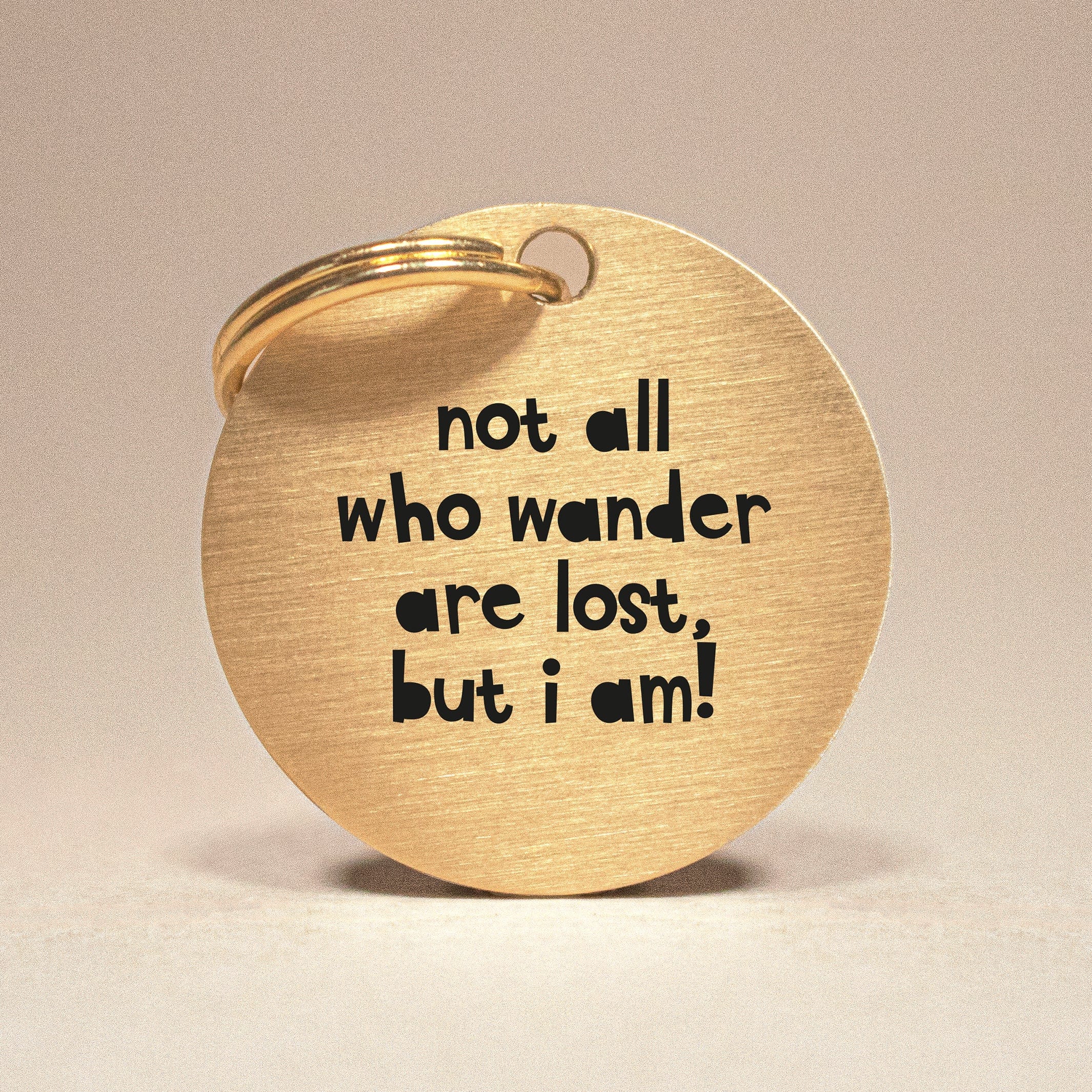 Personalised Gold Brass Dog ID Tag, inscribed with 'Not All Who Wander Are Lost, But I Am! The Stately Hound