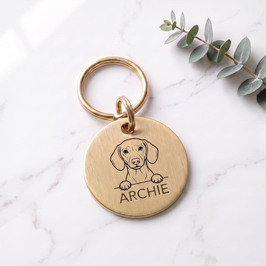 Gold Dachshund dog tag engraved with the Dachshund design and the name ARCHIE