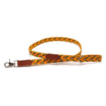 Dog leash with braided design and brown leather accents on a white background