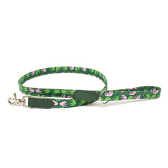 Green dog leash with pink floral pattern on a white background