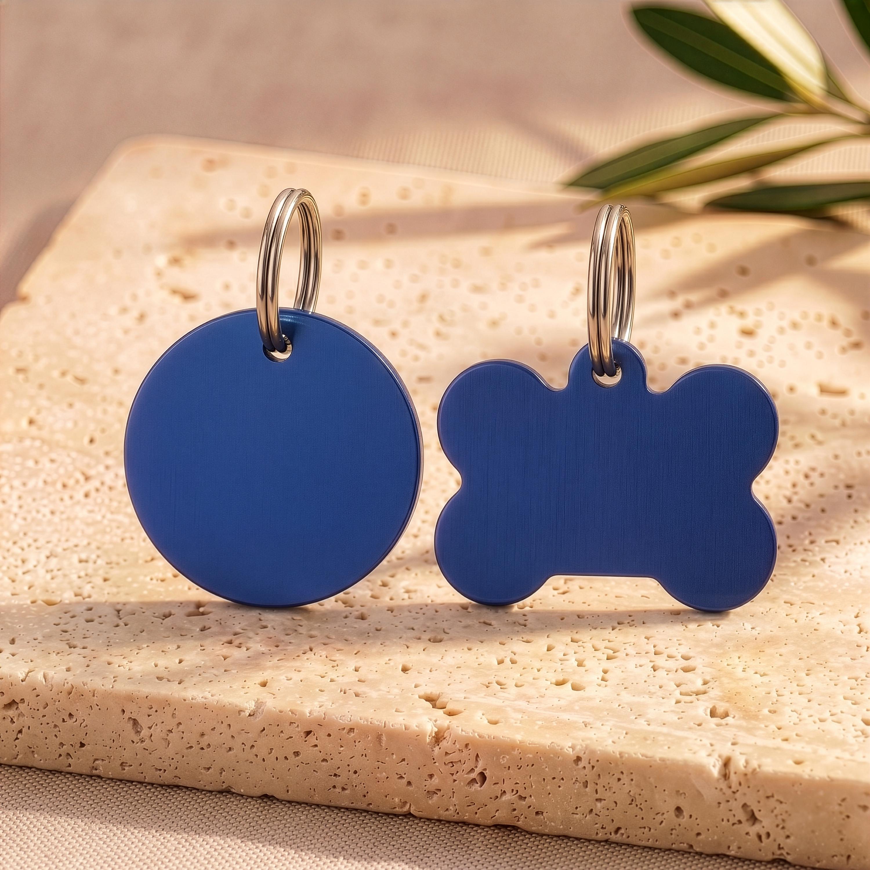 Blue round and bone personalised dog tags in brushed navy, ready for engraving