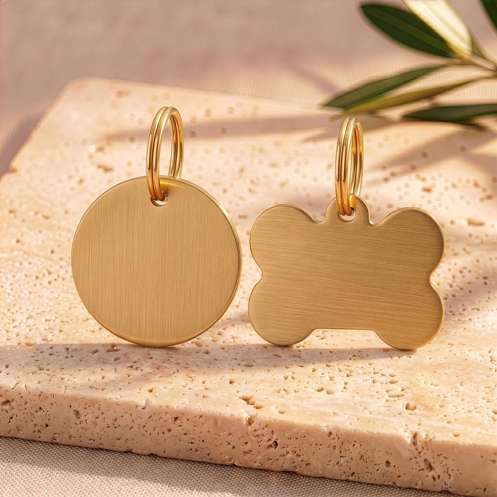 Gold round and bone personalised dog tags showing the brushed gold finish