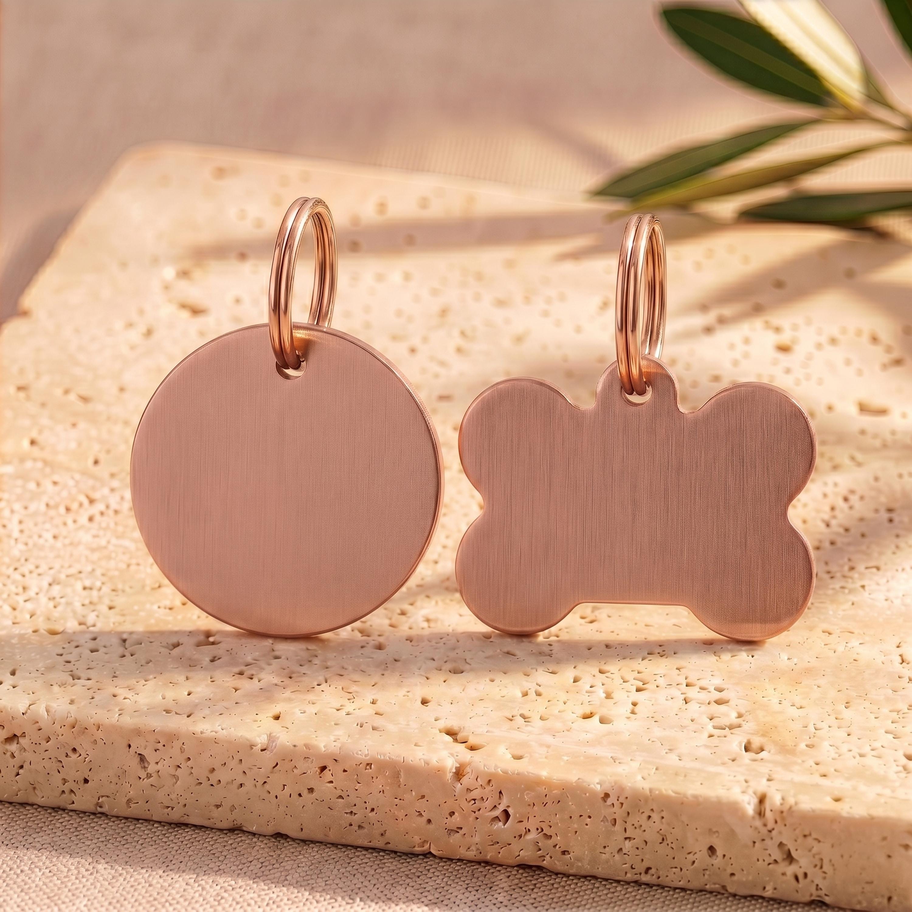 Rose gold round and bone personalised dog tags showing the soft pink-gold finish