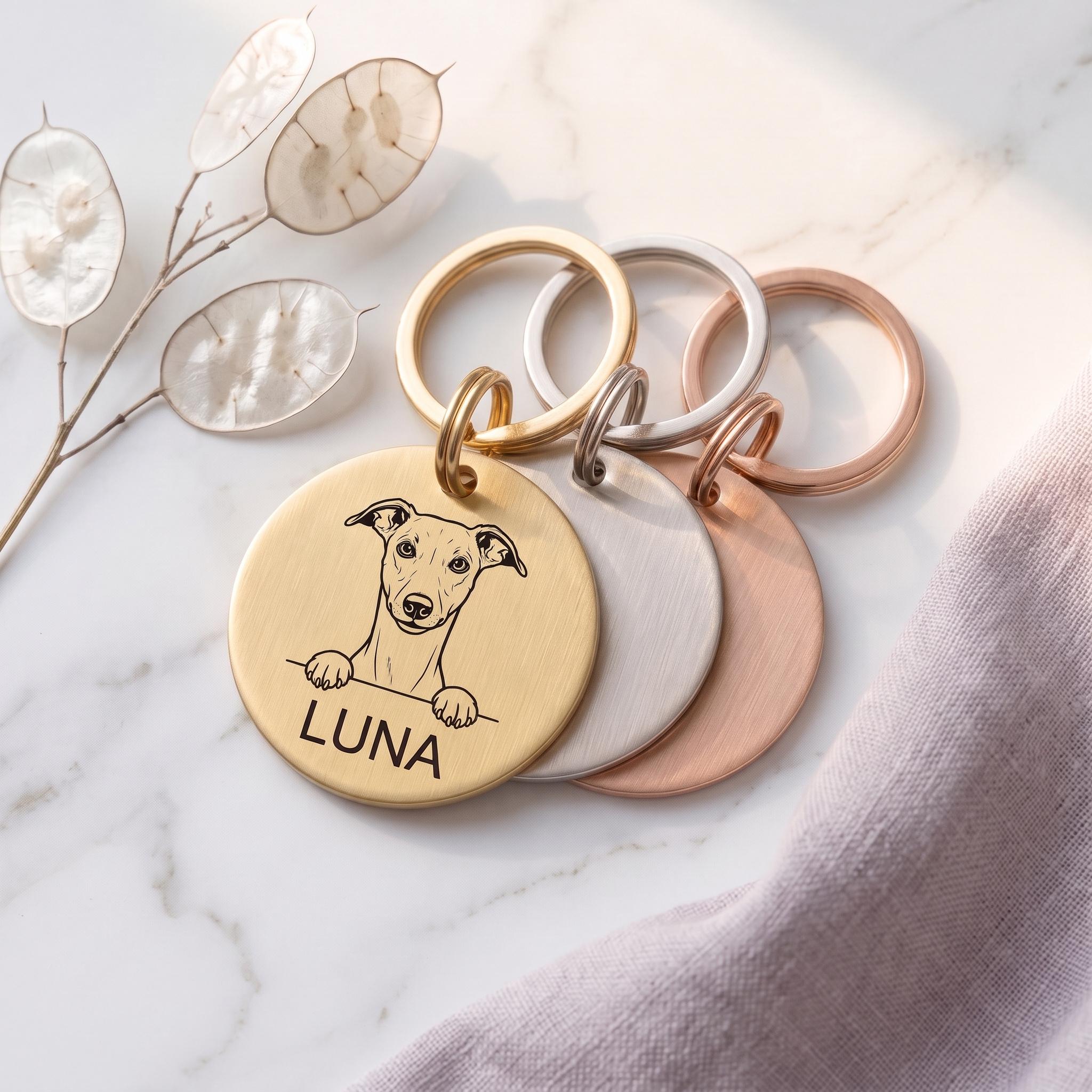 Personalised Whippet dog tags in gold, silver and rose gold, fanned to show all three brushed finishes