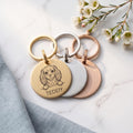 Personalised Cavalier King Charles dog tags in gold, silver and rose gold, fanned to show all three brushed finishes