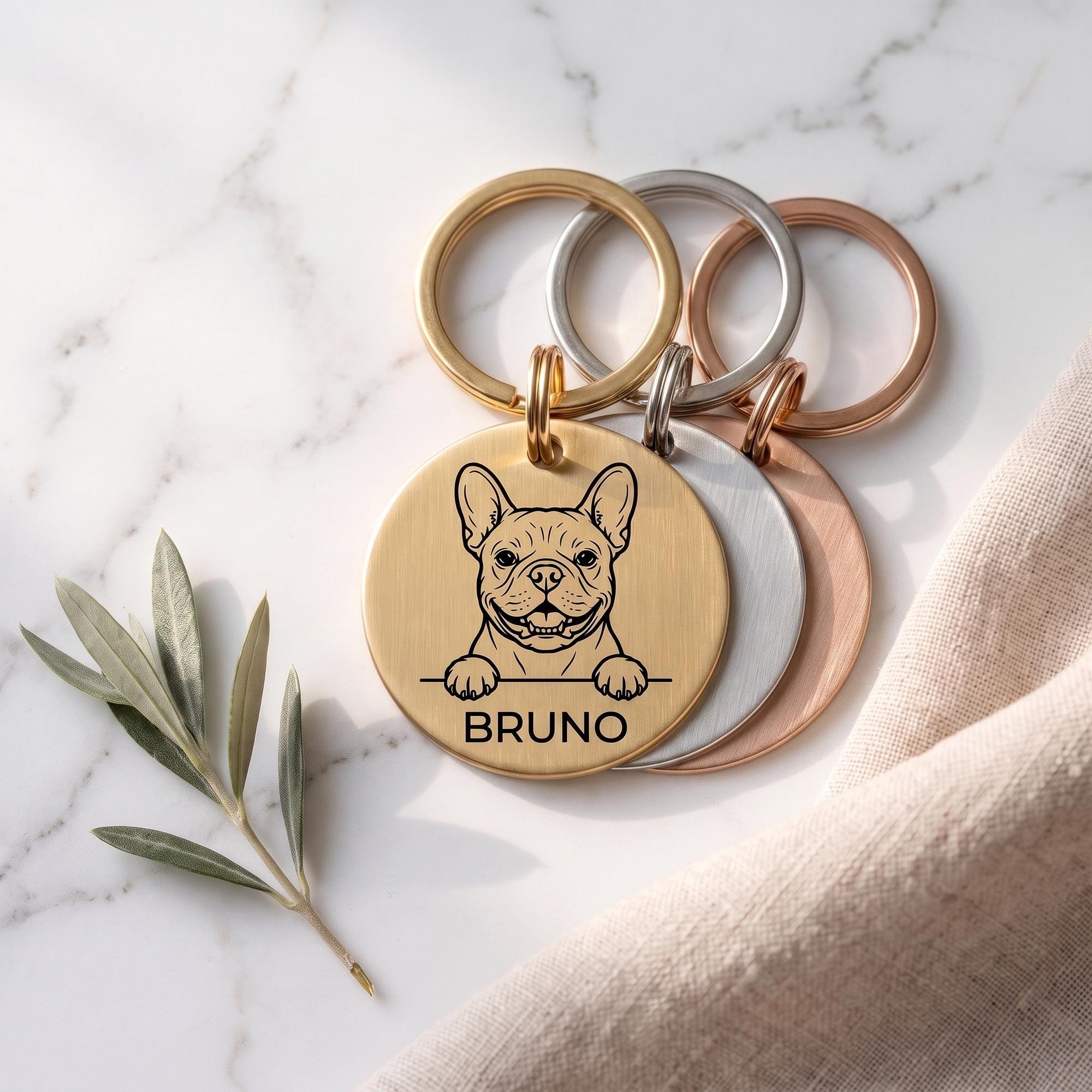 Personalised French Bulldog dog tags in gold, silver and rose gold, fanned to show all three brushed finishes