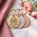 Personalised Cavapoo dog tags in gold, silver and rose gold, fanned to show all three brushed finishes