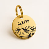 Personalised Dog Name Tag with Engraved Mountain Sunset Design in Gold-Coloured Brass The Stately Hound