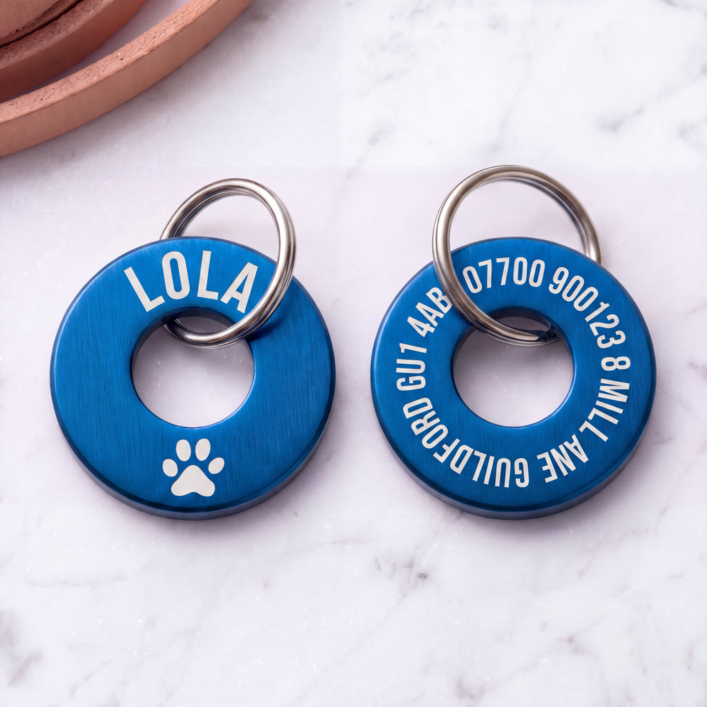 Front and back of the blue washer dog tag - name and symbol on the front, contact details on the back