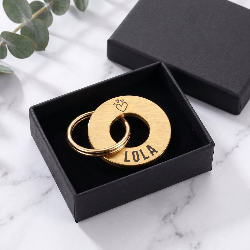 Gold washer dog tag in its matte black gift box