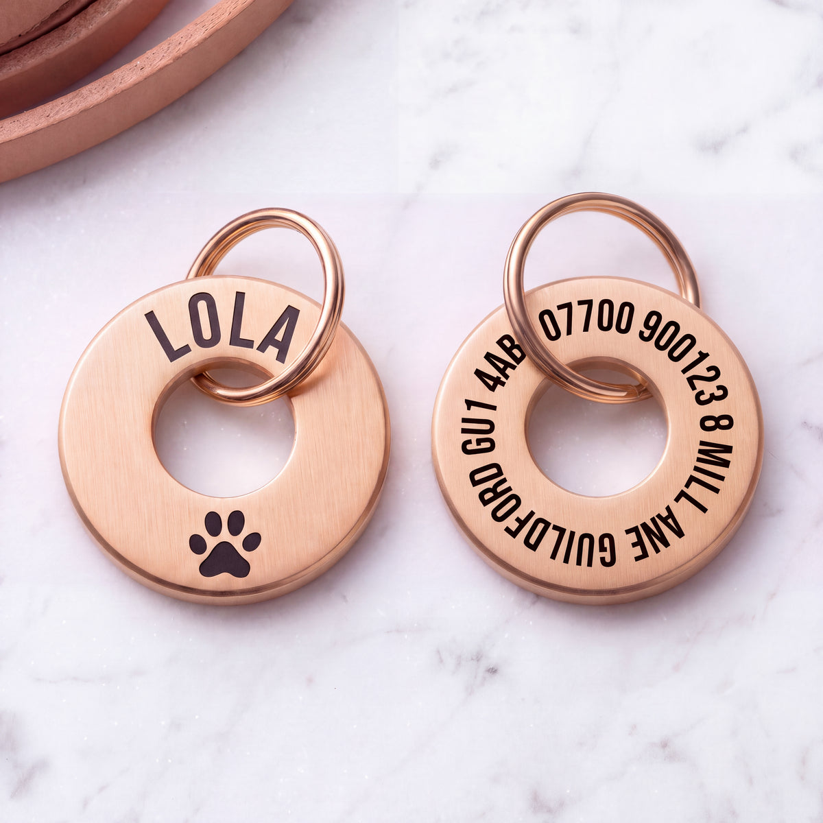 Front and back of the rose gold washer dog tag - name and symbol on the front, contact details on the back